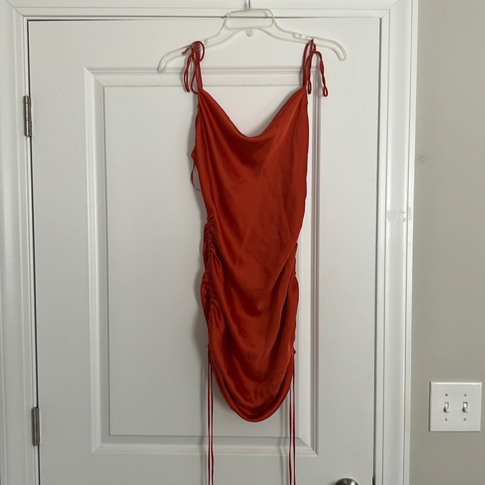 Orange silk/satin dress. Size small. Adjustable straps and length.